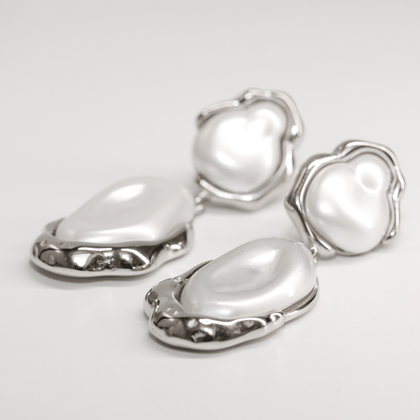 Callista Pearl Drops silver earrings with glowing pearls and smooth metallic design
