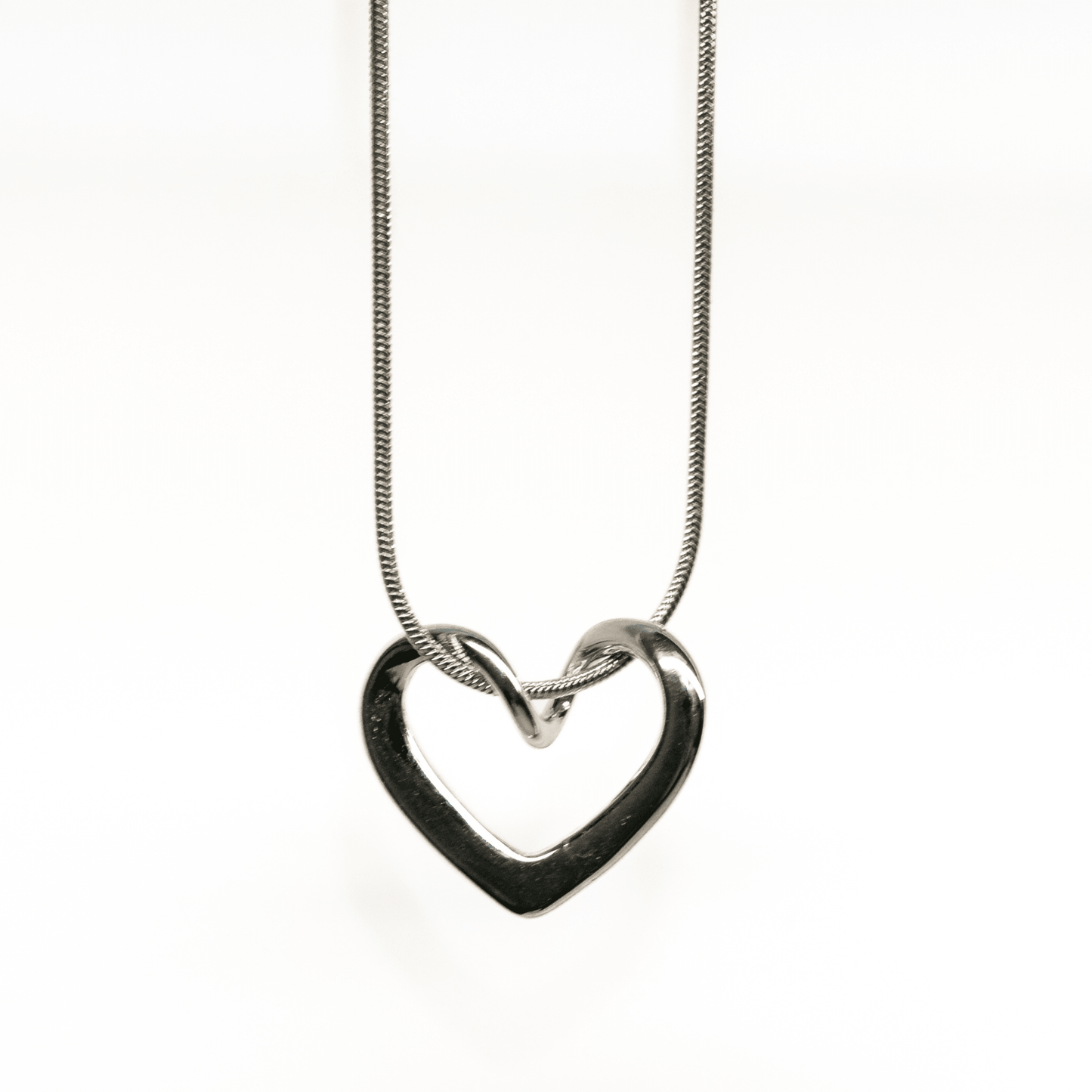 The Unity Heart Necklace, Silver open-heart pendant necklace with sleek curved design.