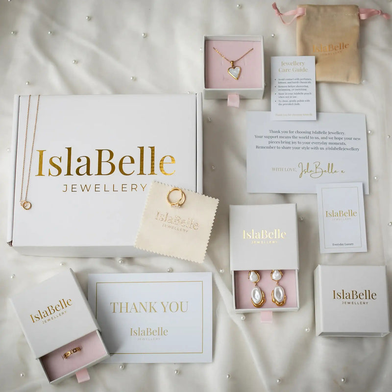IslaBelle Jewellery packaging with jewelry and accessories on a light background
