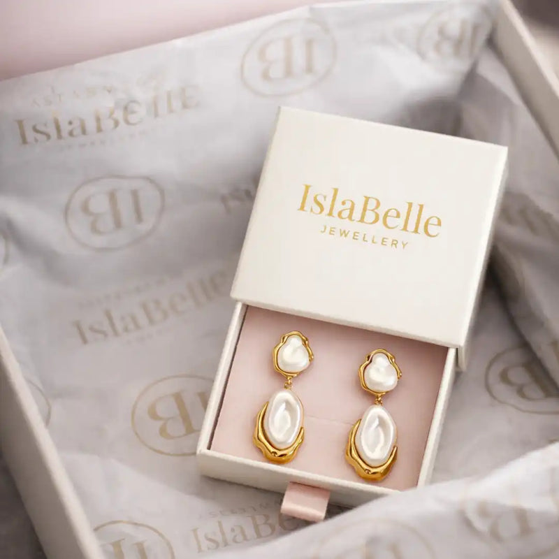 IslaBelle jewellery box with gold and pearl earrings on a branded background